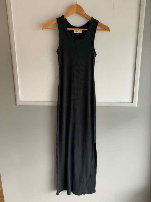 Black sleeveless maxi dress with scoop neckline, slim fit, and soft stretchy fabric.