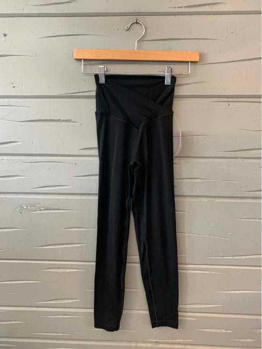 Black high-waisted leggings with a crisscross waistband, slim fit, size XS.