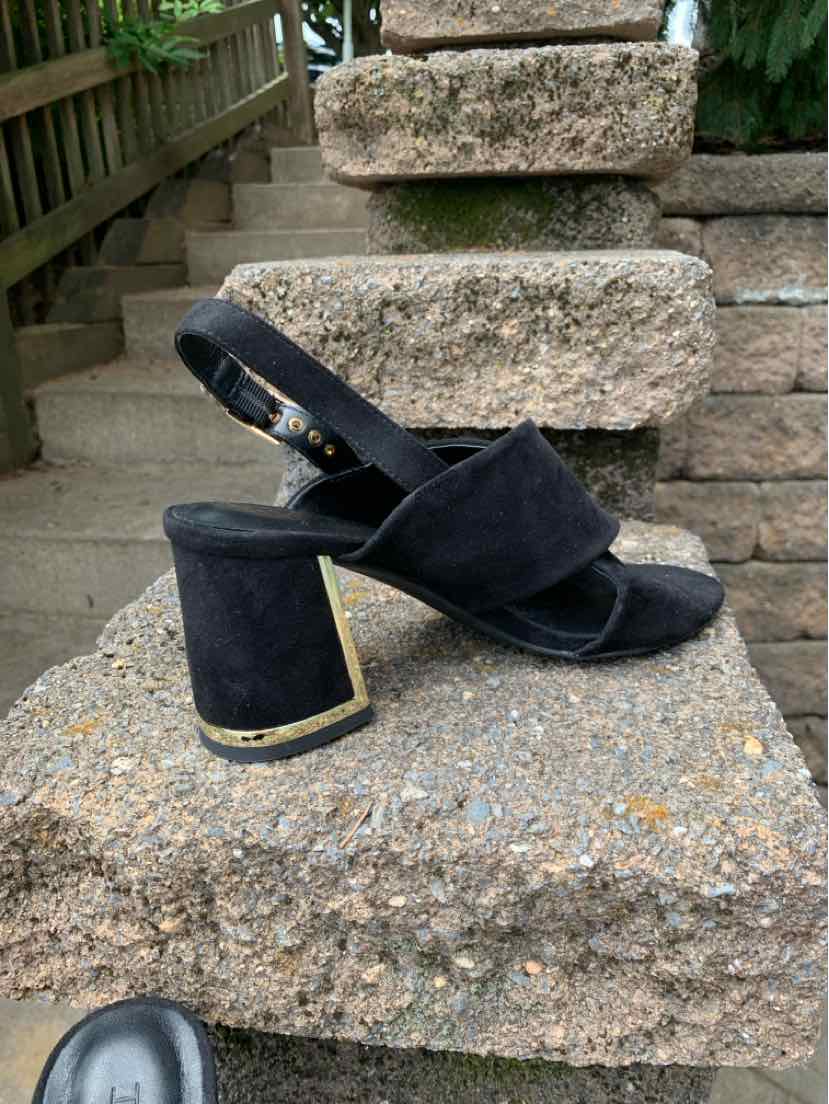 Black suede open-toe block heel sandal with adjustable ankle strap and gold trim on heel, size 8.5.