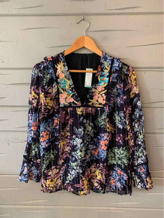 Black floral blouse with long sleeves and a ruffled V-neck collar, size 12.