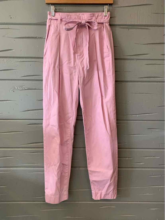Soft pink toddler pants with a paperbag waist and a fabric belt tied in a bow.