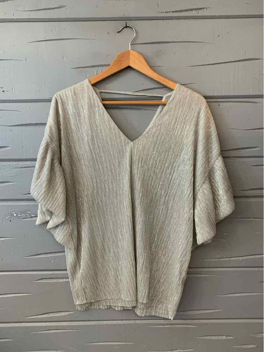 Light beige textured knit blouse with a V-neck, short flutter sleeves, and a relaxed fit.