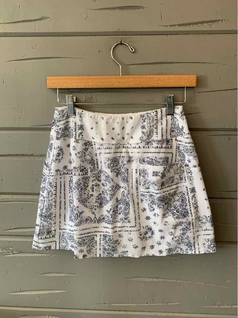 White golf skirt with blue paisley print, size small, soft lightweight fabric, above-knee length.
