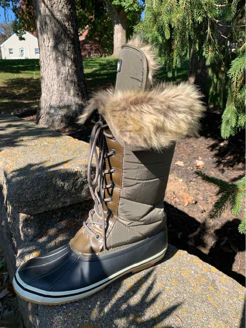 Women’s gray quilted winter boot with a black rubber sole, lace-up front, and tan faux-fur cuff.