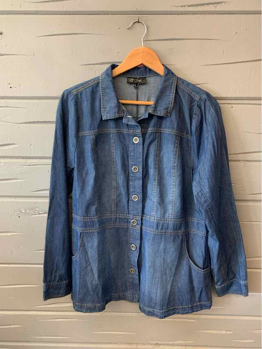 Long-sleeve blue denim jacket with button front and two side pockets hanging on wooden hanger.