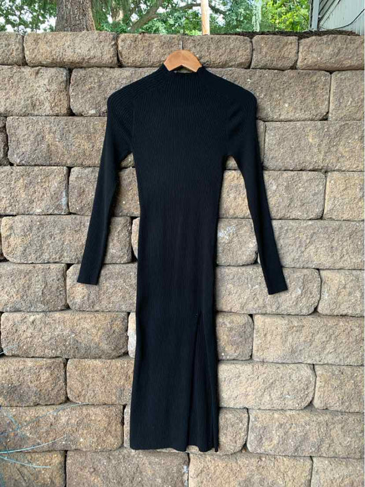 Black long-sleeve knit midi dress with a high neckline and fitted silhouette.