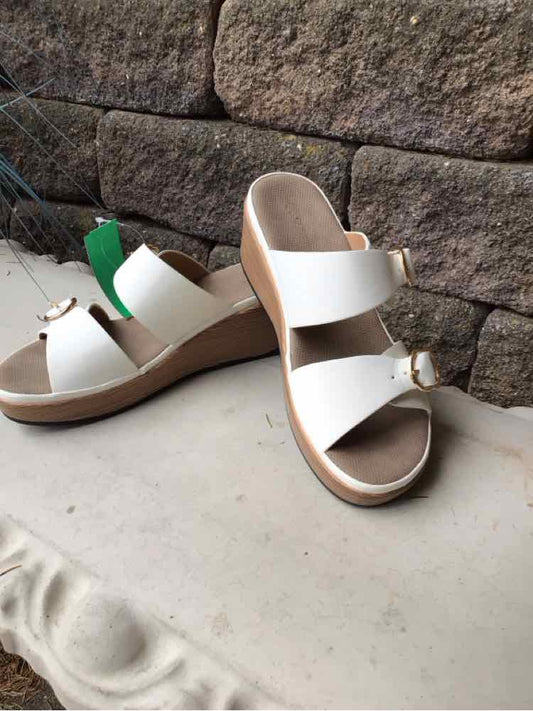 White open-toe slide sandals with wide straps and wooden wedge heels, size 39.