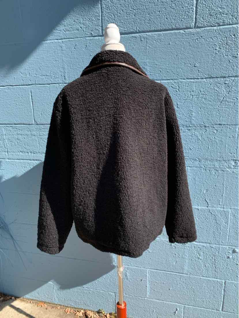 Black women’s Maurices jacket with a soft, fuzzy texture, high collar, and relaxed fit.