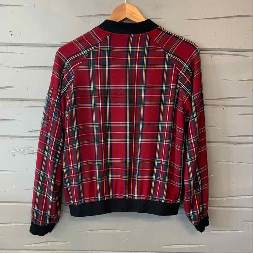 Red plaid button-up shirt with a black collar, cuffs, and hem, shown from the back.