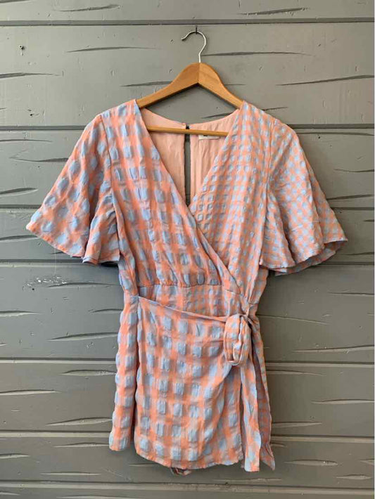 Light blue and white gingham wrap dress with flutter sleeves and side tie belt.
