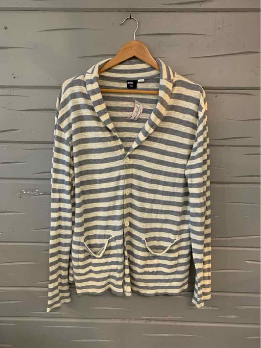 Light gray and white striped cardigan with front pockets and button closure on wooden hanger.