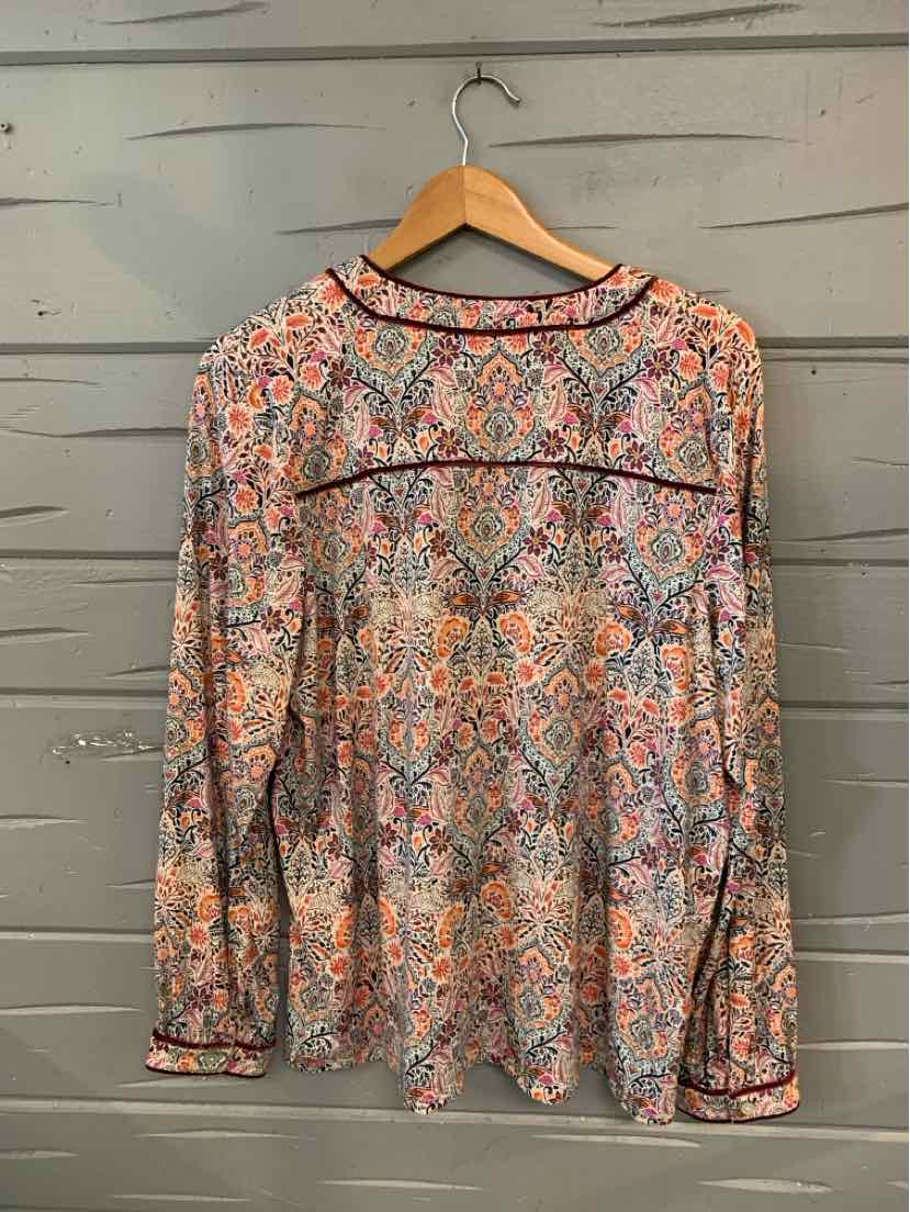 Long-sleeve blouse with multicolored paisley pattern, round neckline, and black piping detail.