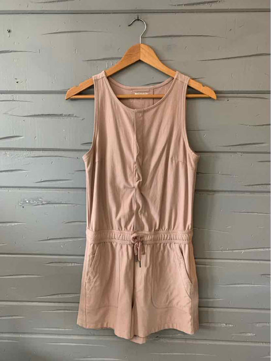 Sleeveless tan romper with cinched waist, round neckline, and soft lightweight fabric.