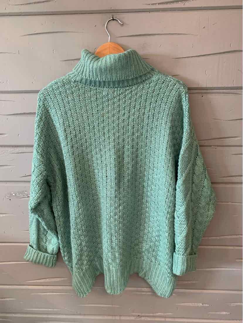 Light green chunky knit turtleneck sweater with textured waffle pattern and long sleeves.