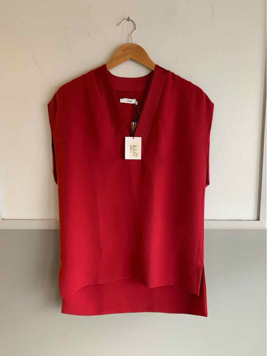 Red short-sleeve blouse with V-neck and relaxed fit on wooden hanger.