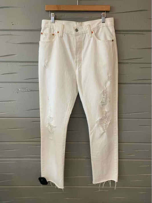 Off-white Levi's jeans with distressed knees and frayed hems, size 8.