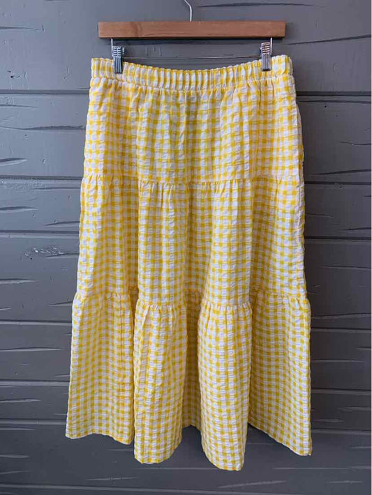 Yellow and white gingham midi skirt with elastic waistband and tiered ruffle hem.