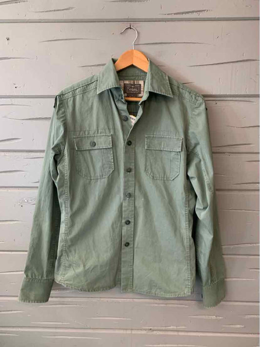 Light olive green long-sleeve button-up shirt with chest pockets and collar on wooden hanger.