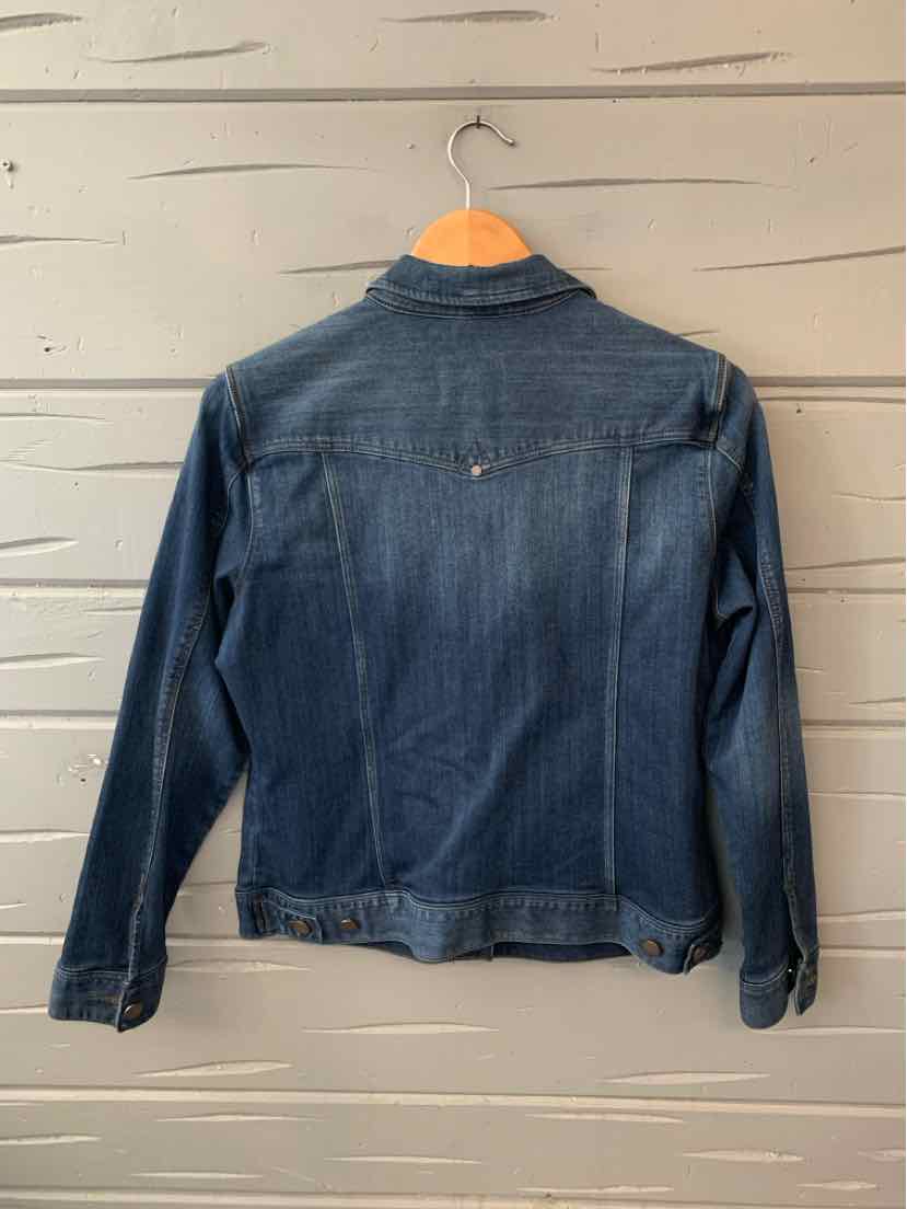 Dark blue denim jacket with button cuffs and a classic collar hanging on wooden hanger.