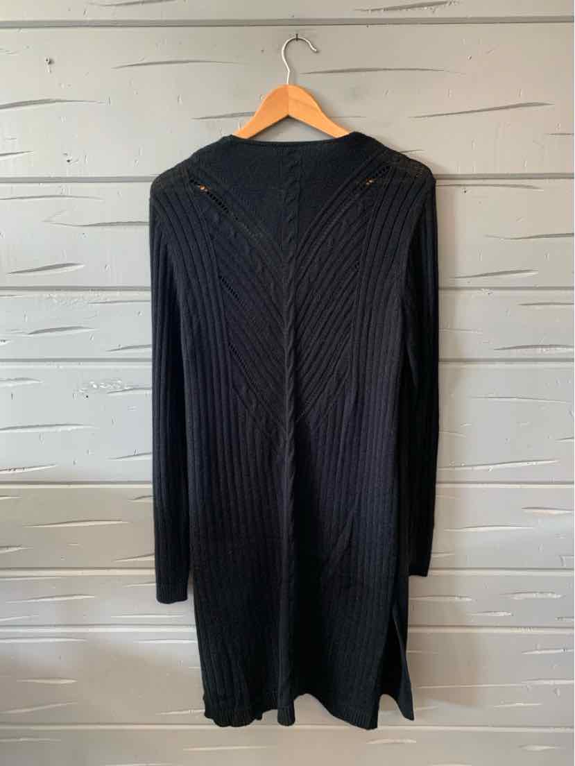 Black ribbed knit long-sleeve sweater dress with side slits in XL size on wooden hanger.