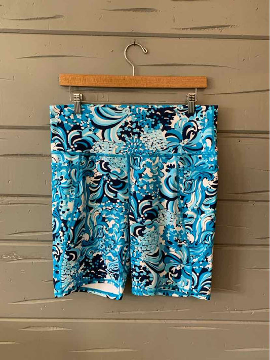 Blue paisley patterned shorts with white and black details, tailored fit, XL size, hanging on wooden hanger.