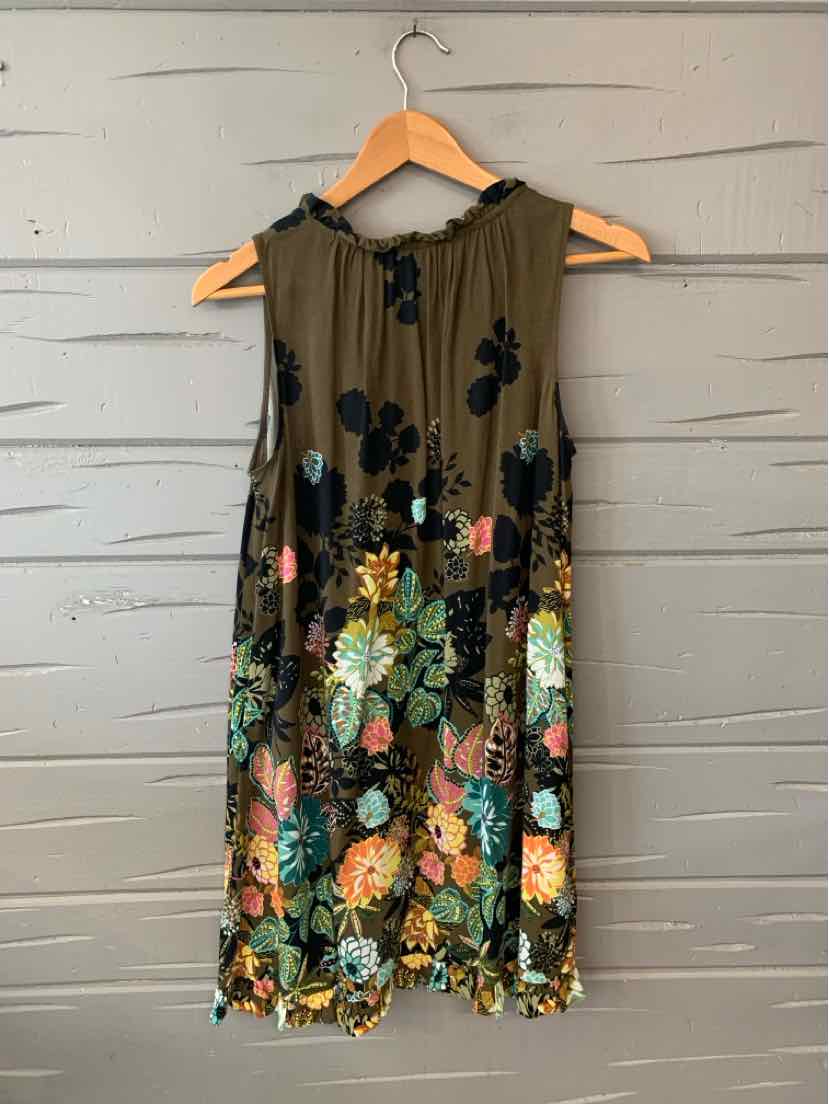 Sleeveless green dress with colorful floral embroidery and ruffled neckline on wooden hanger.