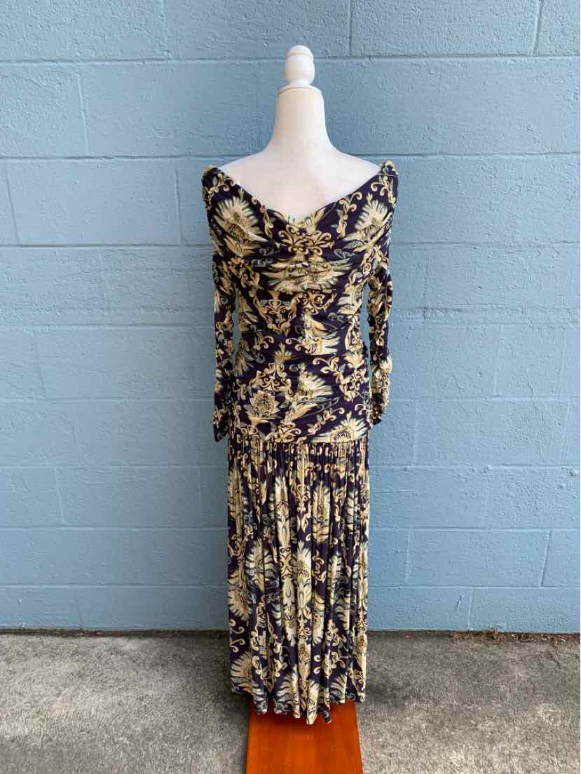 Long-sleeve maxi dress with a multi-color abstract floral pattern in navy, beige, and yellow tones.