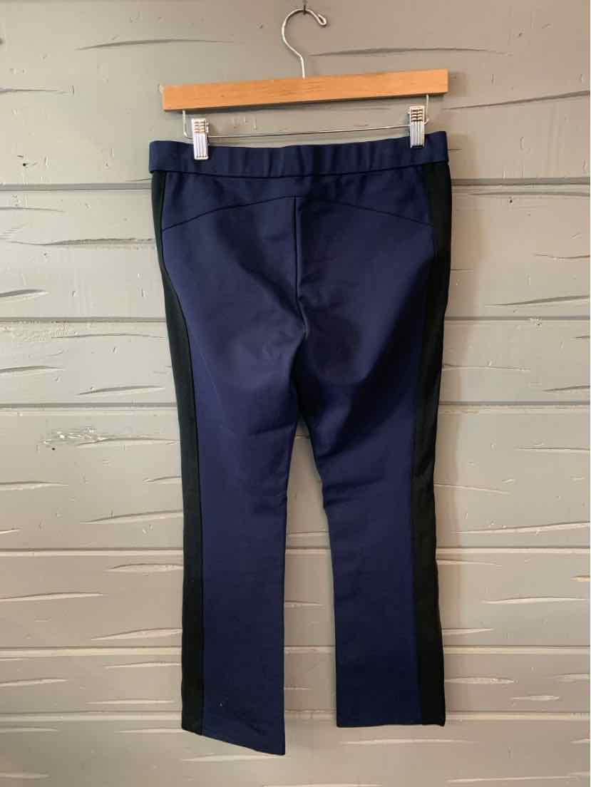 Navy blue mid-rise pants with elastic waistband, straight leg and cropped length hanging on wooden hanger.
