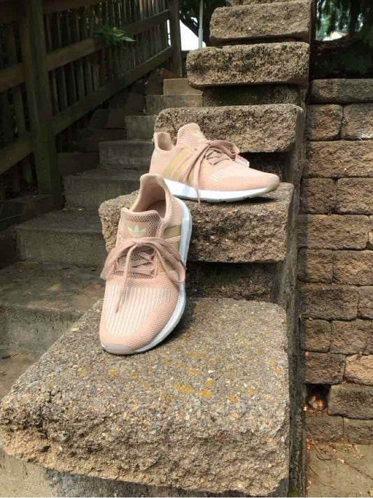 Tan Adidas low-top sneakers with mesh upper, white cushioned sole, and matching tan laces, size 5.5.