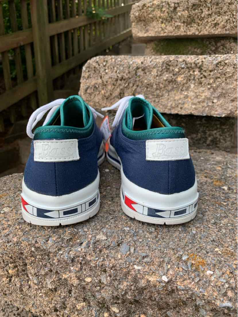 Navy and teal low-top sneakers with white soles and red, blue, and black sole accents, size 7.