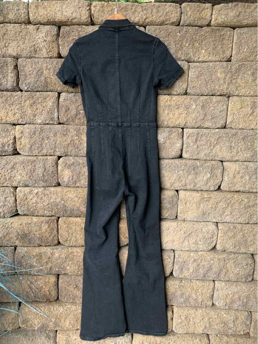 Black denim jumpsuit with short sleeves and flared legs, back zipper closure.