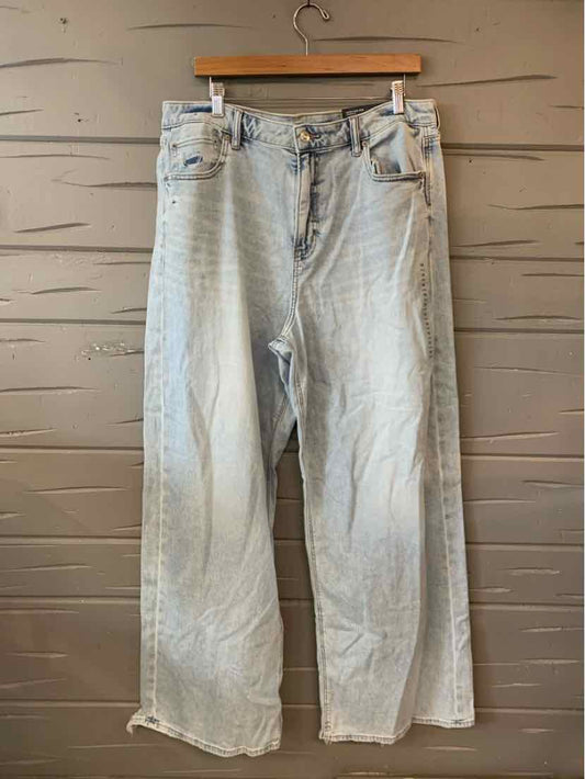 Light wash denim jeans with a loose fit, high waist, five-pocket design, and frayed hems.