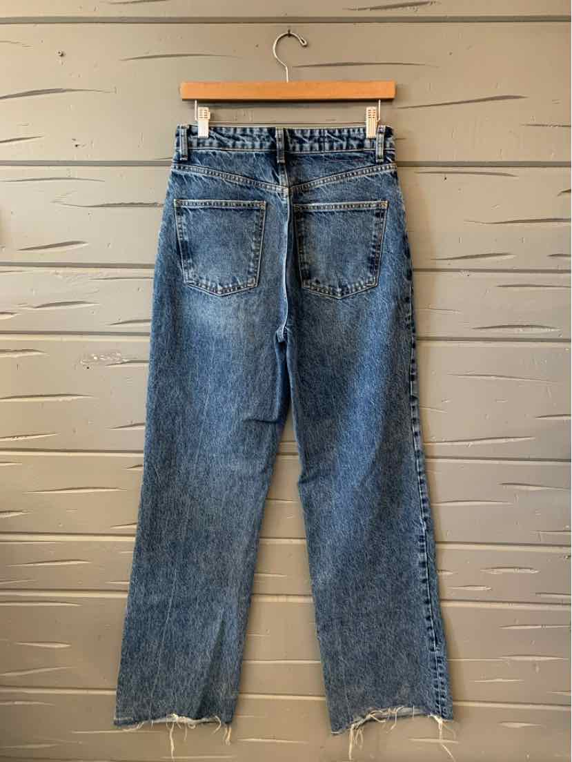 Faded blue Zara jeans with a straight-leg cut, distressed whiskering, and frayed hems, shown from the back.