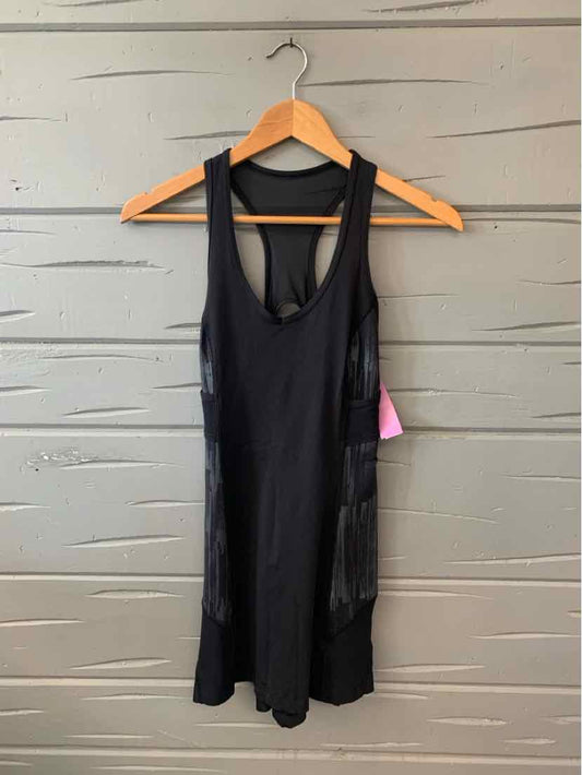 Black sleeveless athletic tank top with racerback and built-in sports bra hanging on wooden hanger.