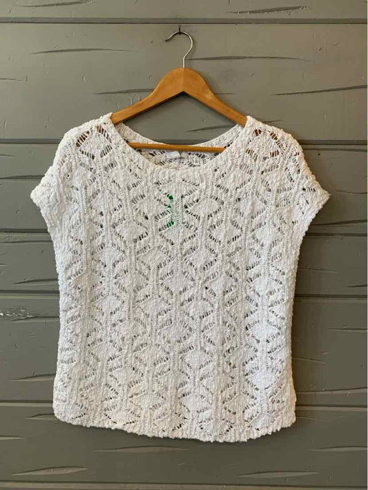 White short-sleeve knit top with openwork diamond pattern and round neckline.