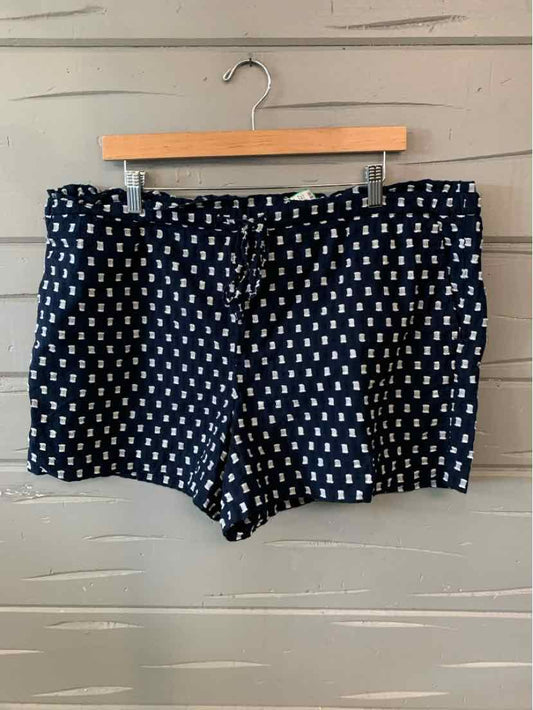 Navy blue shorts with white square pattern, mid-rise waist, and tailored fit.