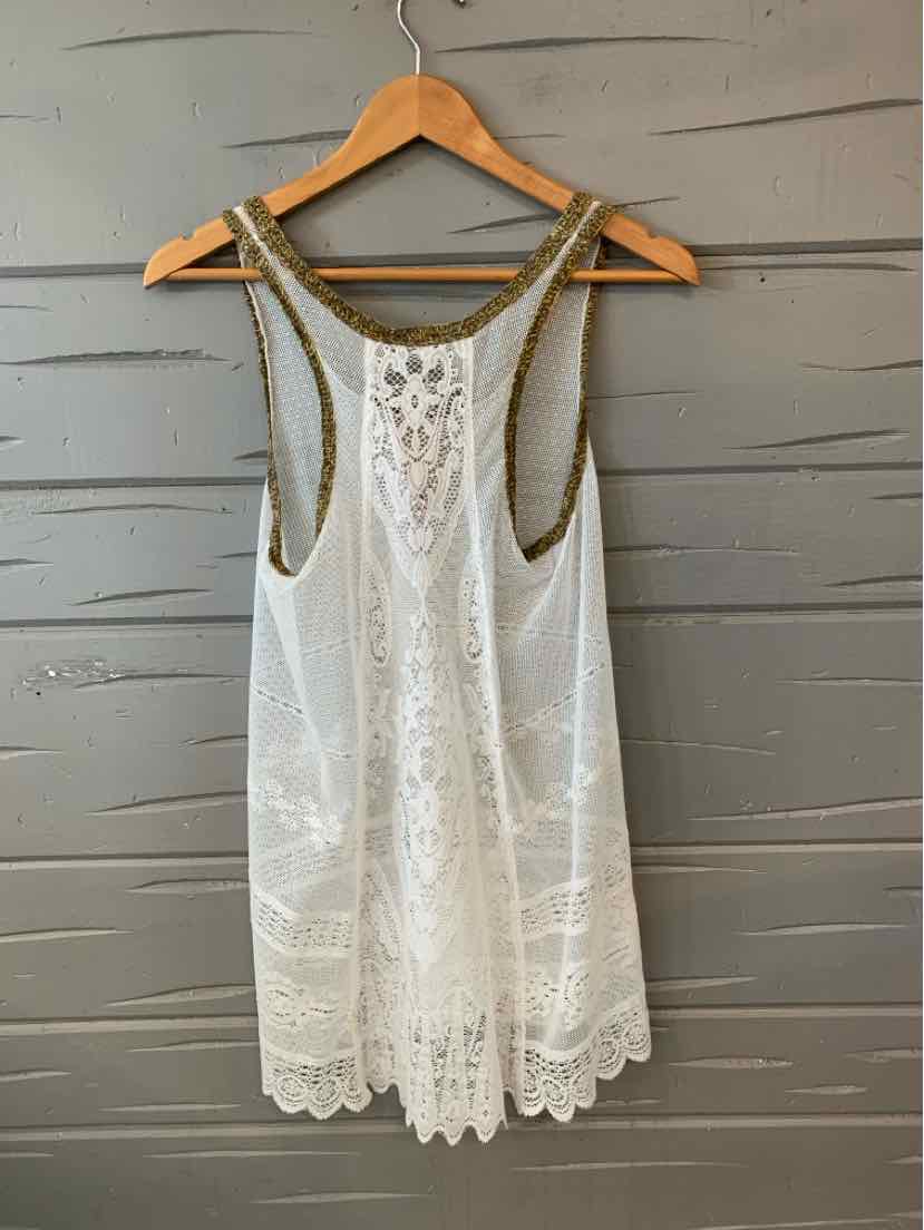 White sleeveless lace tank top with intricate floral patterns and scalloped hem on wooden hanger.