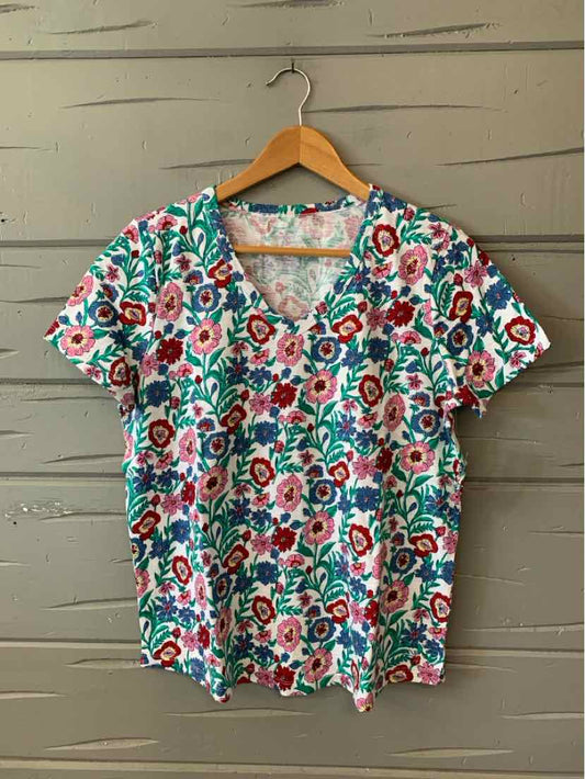 Short-sleeve V-neck shirt with colorful floral print in red, teal, and white, size medium.