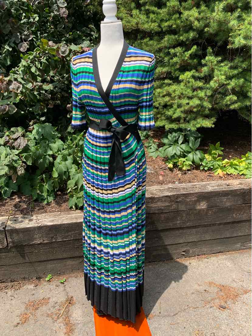 Blue, green, and white striped wrap dress with black trim and pleated black hem.