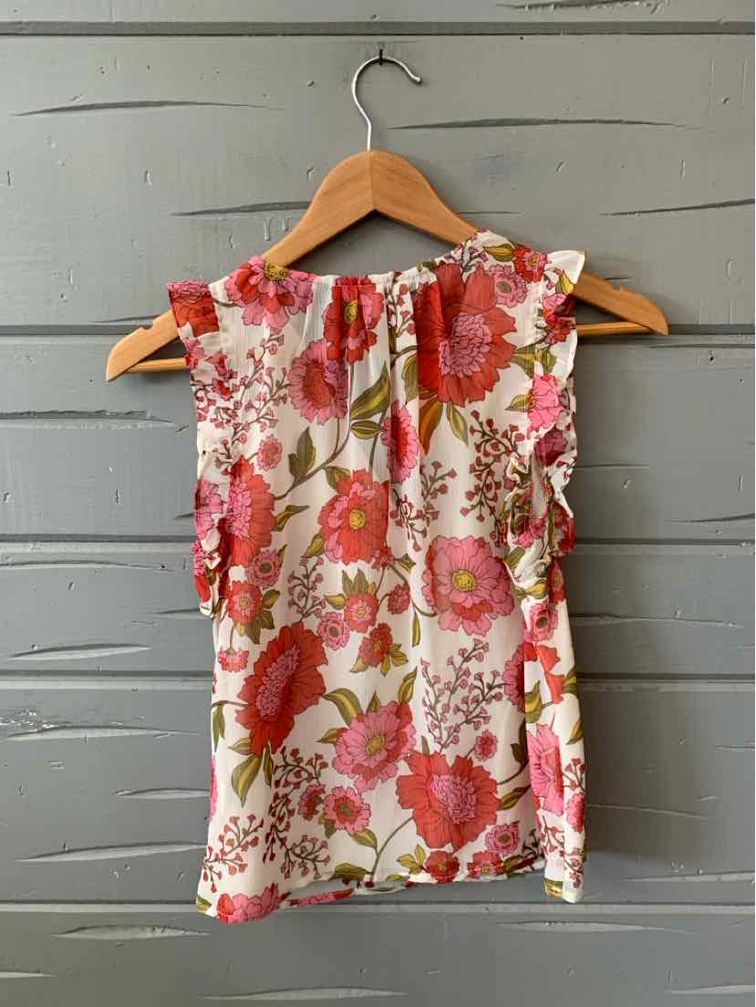 Sleeveless floral blouse with red and pink flowers on white background, ruffle detail on shoulders, lightweight fabric.