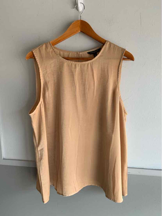 Beige sleeveless blouse with round neckline, loose fit, and smooth fabric on wooden hanger.