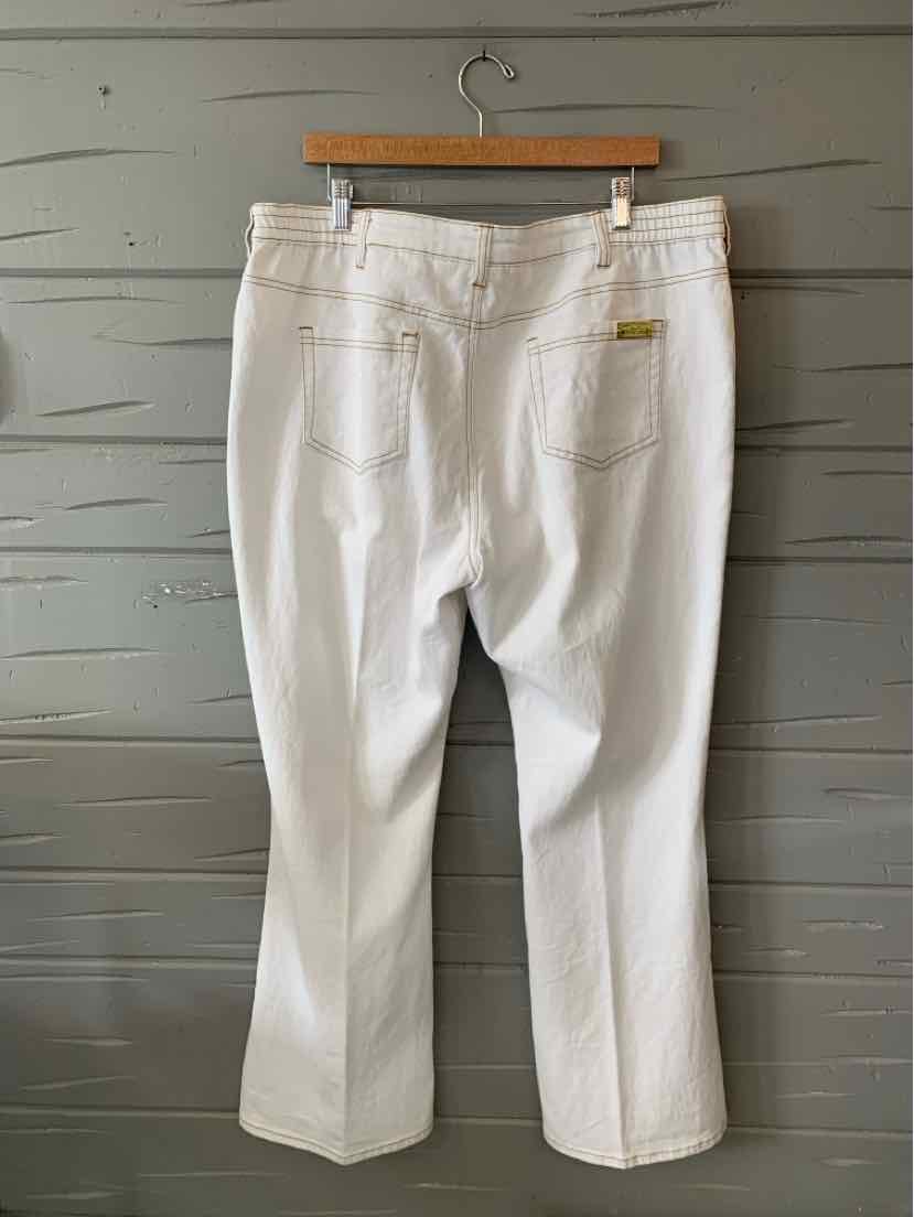 White straight-leg pants with back pockets and belt loops hanging on wooden hanger.