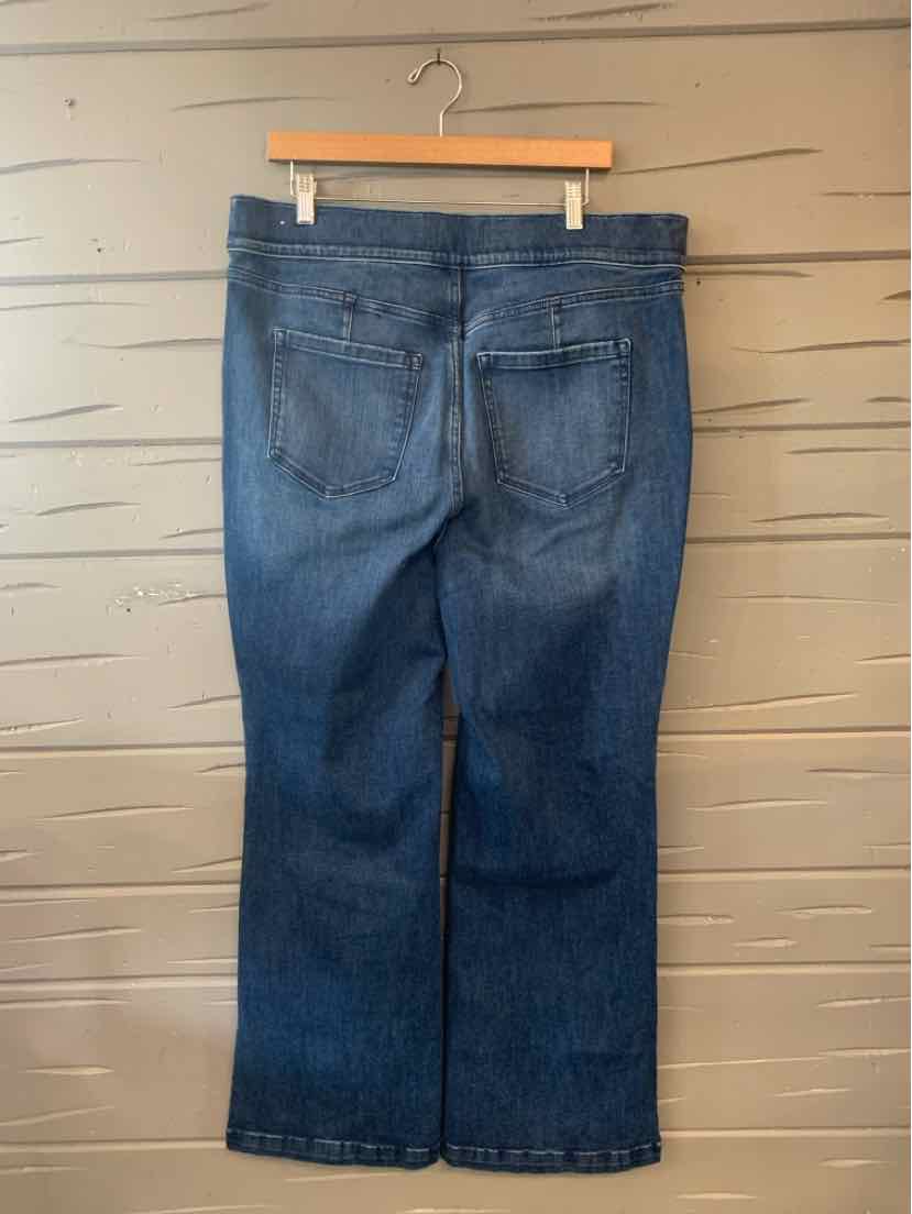 Dark blue denim jeans with a straight leg cut and two back pockets hanging on a wooden hanger.