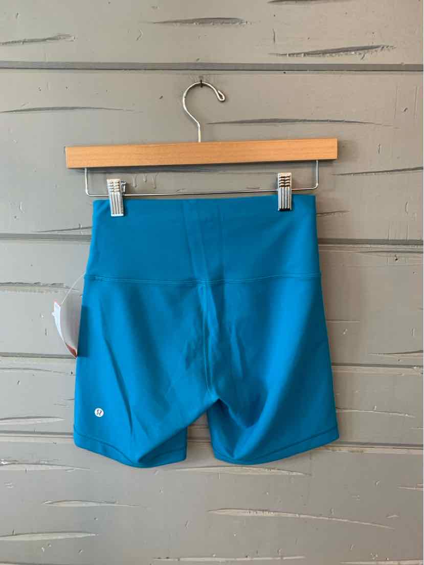 Bright blue high-waist athletic shorts with flat seams and a small reflective logo on left leg.