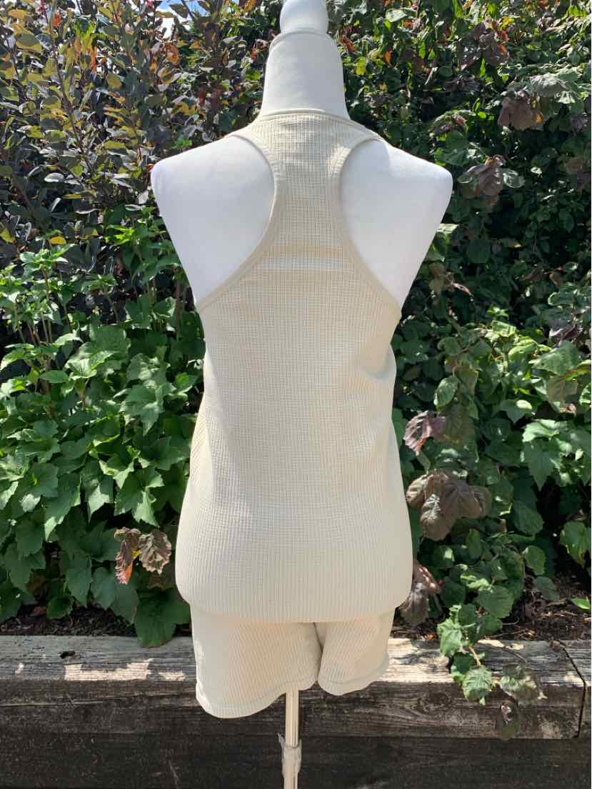 Tan racerback tank top with fitted silhouette made of soft fabric, size XL.