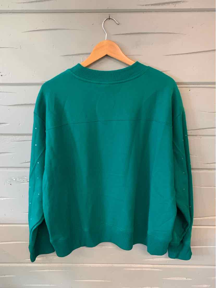 Green long-sleeve sweatshirt with a crew neckline in XL size hanging on wooden hanger.