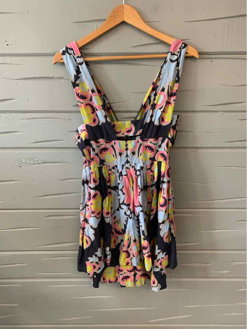 Floral-print sleeveless dress with deep V-neck and cinched waist on wooden hanger.