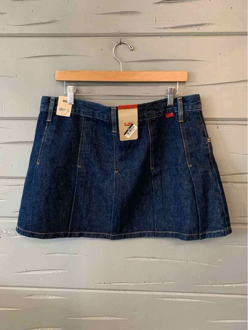 Dark blue denim mini skirt with front pleats and a leather Levi's logo patch on the waistband.