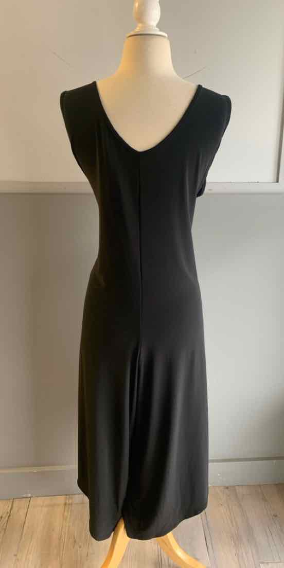 Black sleeveless midi dress with a deep scoop neckline on a mannequin.