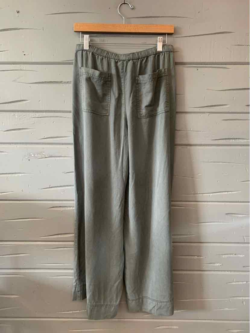 Gray straight-leg pants with elastic waistband and rear pockets hanging on wooden hanger.